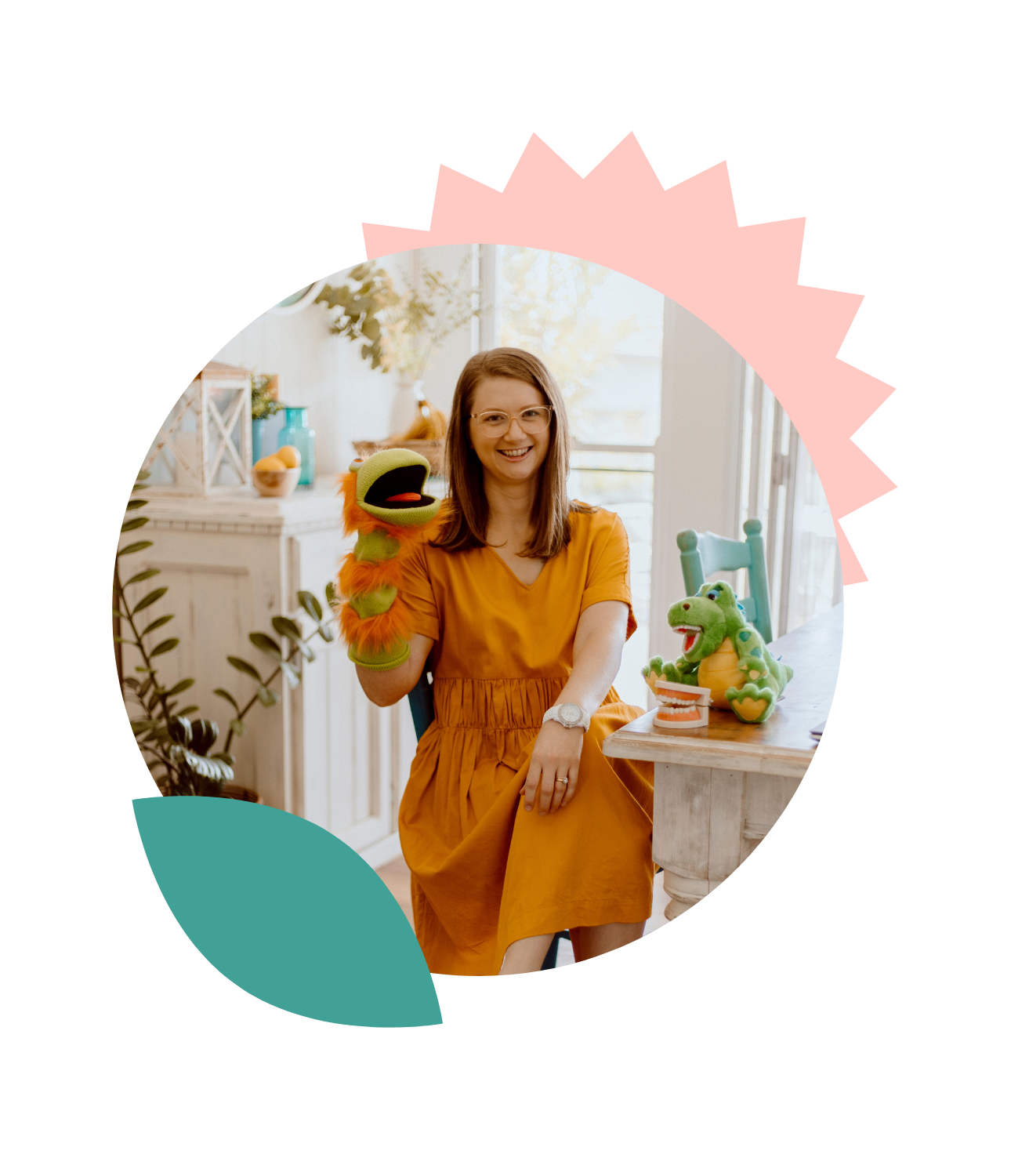 Oral health therapist Mel Van Schelven from The Face Place sitting in a bright home clinic, smiling with a puppet and children’s dental teaching toys, supporting families with children’s oral health and function.