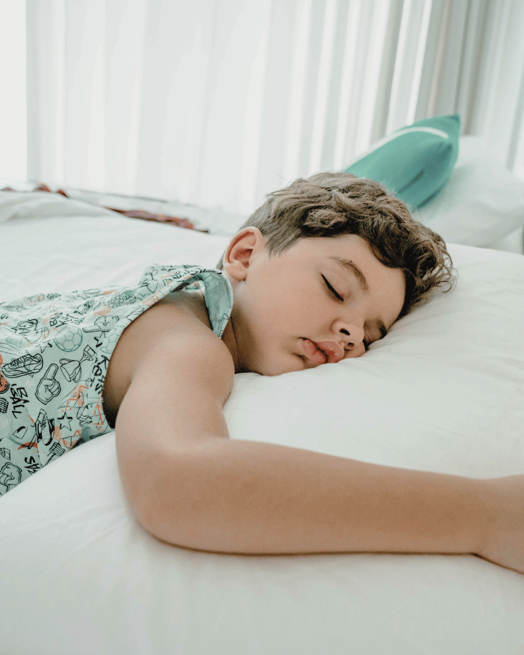 Young boy sleeping with mouth open, illustrating mouth breathing during sleep in children