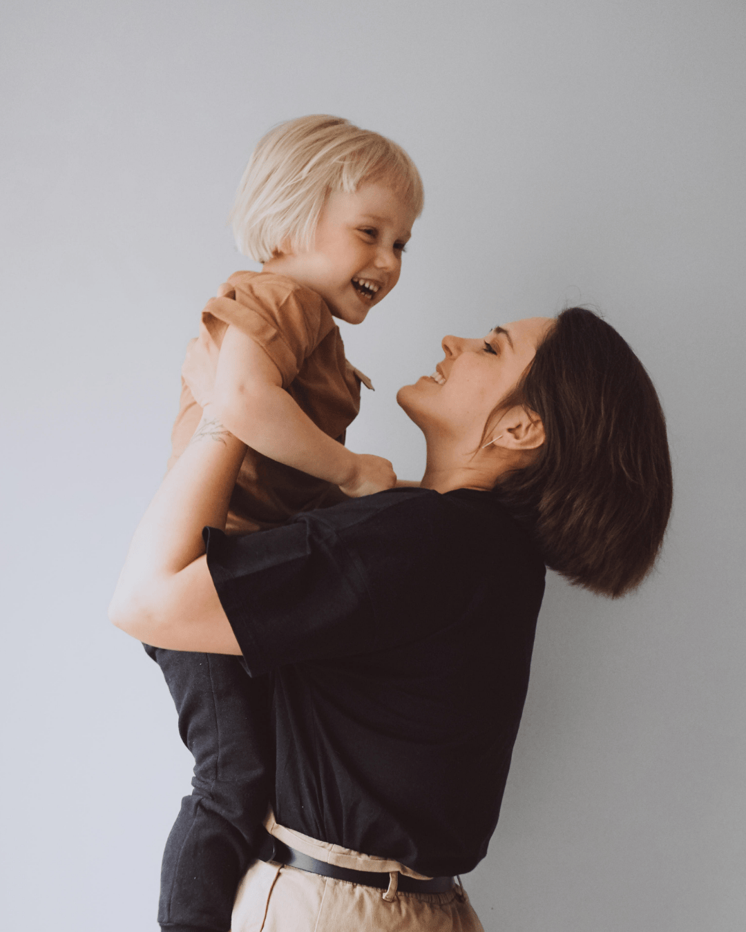 Mother and toddler smiling together during toothbrushing routine – toddler oral hygiene support.