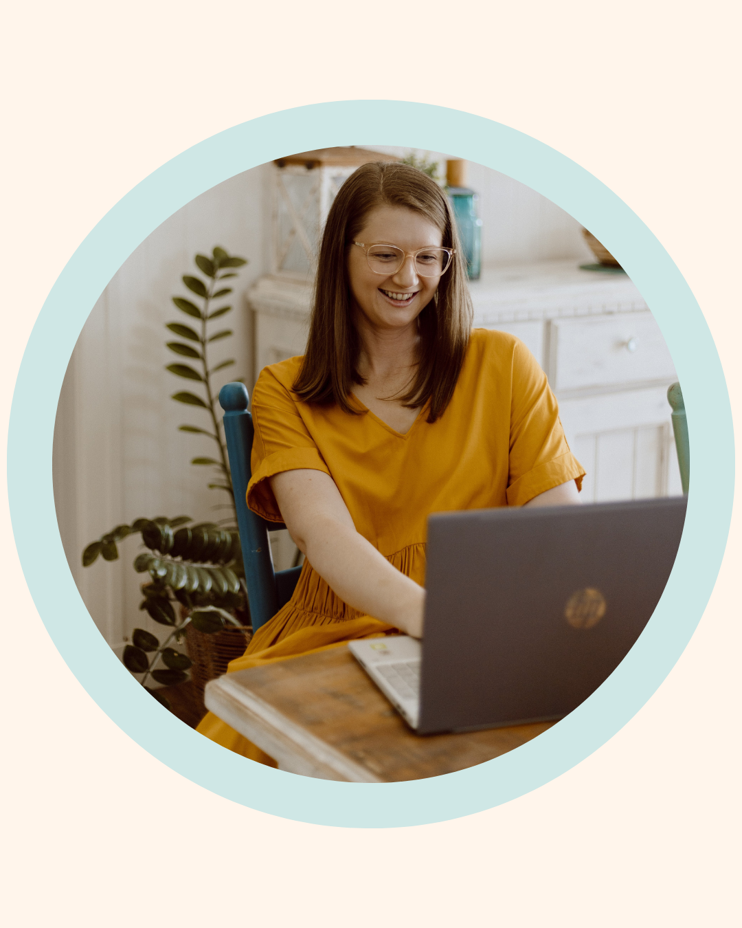 Mel from The Face Place smiling at her laptop during an online children's oral function consultation